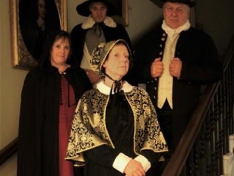 Costumed guides wait to welcome you